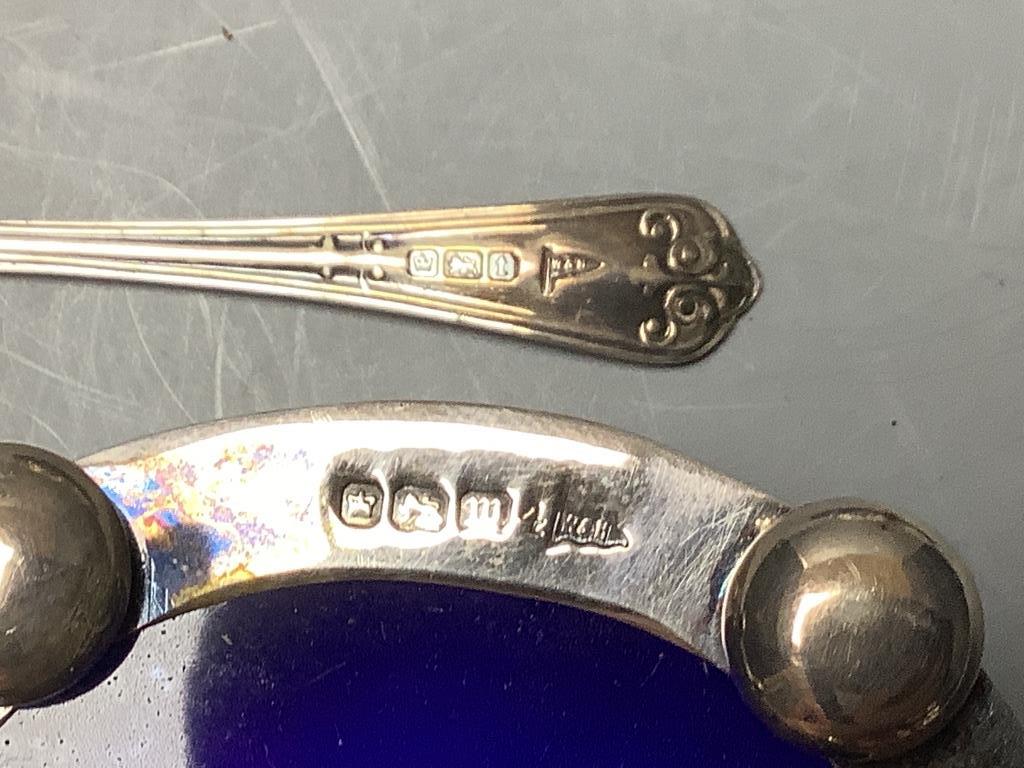 A cased set of four Edwardian, pierced silver oval salts, with blue glass liners, Sheffield, 1904 and four associated spoons